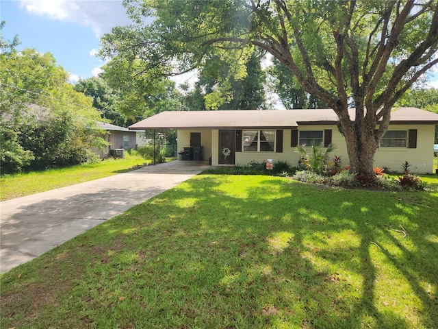 220 Pinehurst Dr, Auburndale, FL 33823 - single story home featuring concrete driveway, an attached carport, and a front lawn