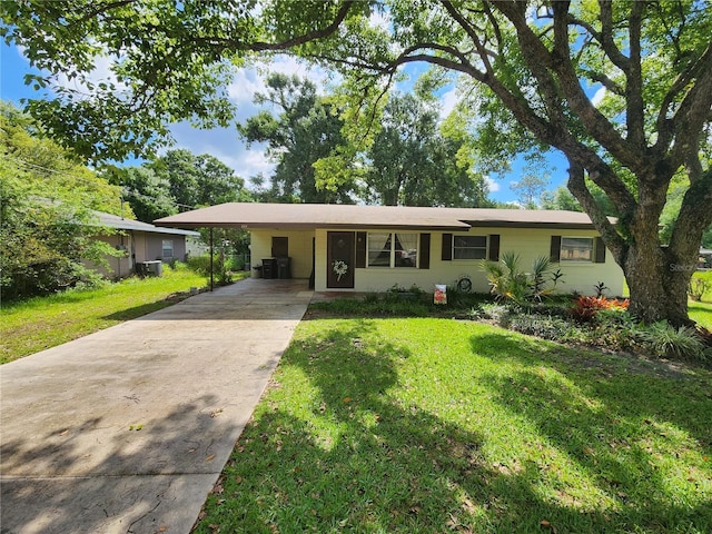 220 Pinehurst Dr, Auburndale, FL 33823 - single story home featuring concrete driveway, a front yard, and an attached carport