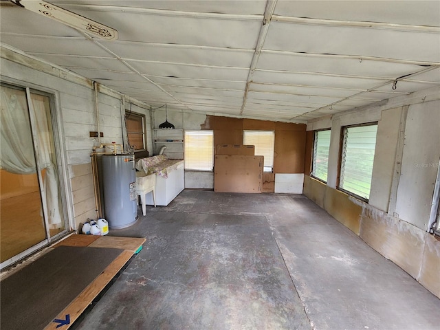220 Pinehurst Dr, Auburndale, FL 33823 - miscellaneous room featuring electric water heater, concrete flooring, and plenty of natural light
