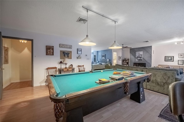 16 Golfview Cir NE, Winter Haven, FL 33881 - playroom featuring light wood finished floors, a textured ceiling, billiards, and rail lighting