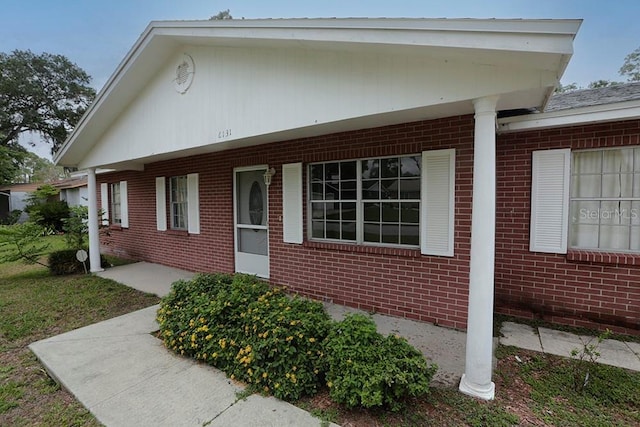 view of side of property featuring brick siding