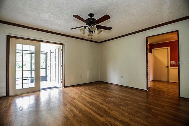 empty room featuring dark wood-style flooring, ceiling fan, a textured ceiling, and crown molding