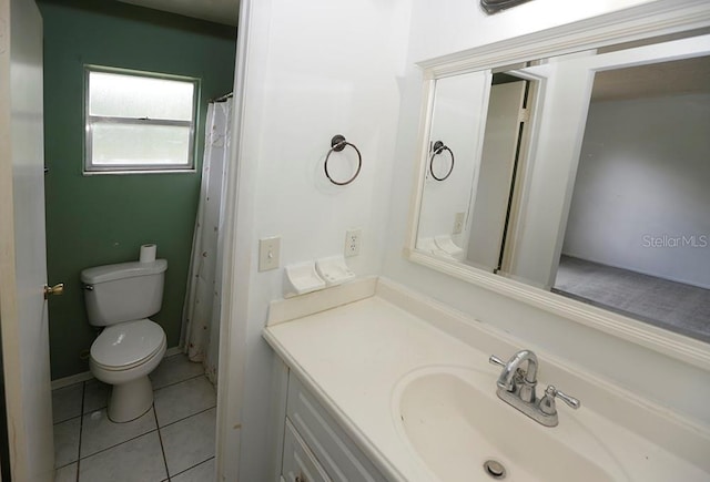full bathroom with toilet, vanity, and tile patterned flooring