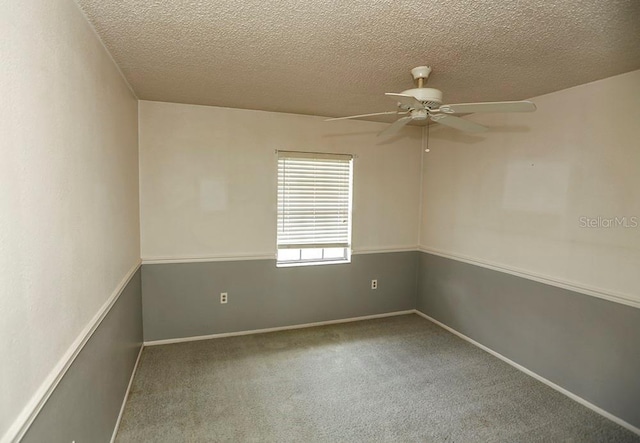 spare room featuring a ceiling fan, carpet flooring, a textured ceiling, and baseboards