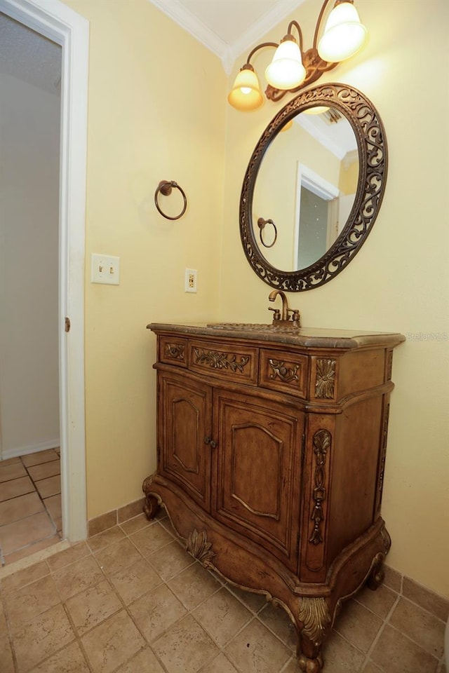 bathroom with ornamental molding, baseboards, and vanity
