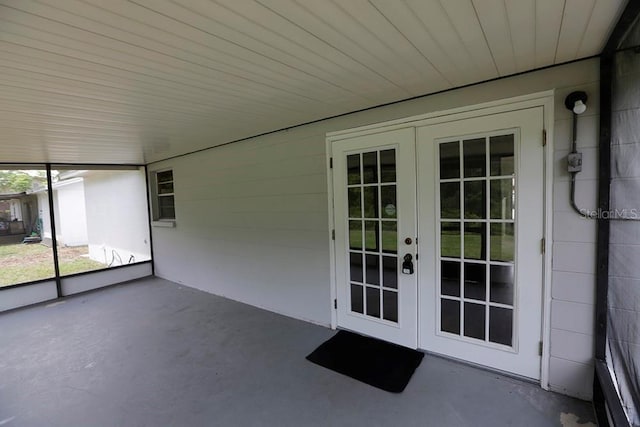 unfurnished sunroom with french doors