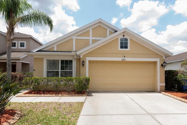 12654 Belcroft Dr, Riverview, FL 33579 - view of front of property with stucco siding, concrete driveway, and a garage