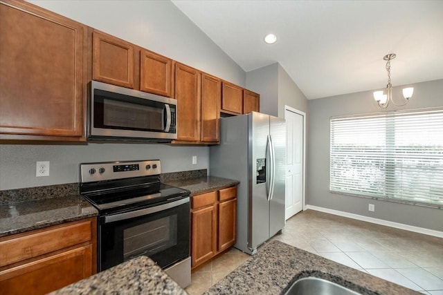 12654 Belcroft Dr, Riverview, FL 33579 - kitchen with appliances with stainless steel finishes, vaulted ceiling, a chandelier, brown cabinets, and light tile patterned flooring