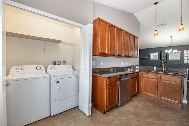12654 Belcroft Dr, Riverview, FL 33579 - kitchen featuring stainless steel dishwasher, a sink, washer and clothes dryer, a chandelier, and brown cabinets