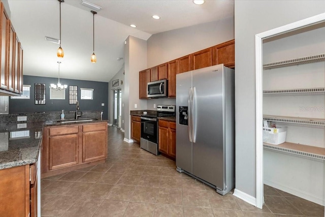 12654 Belcroft Dr, Riverview, FL 33579 - kitchen with appliances with stainless steel finishes, a sink, a chandelier, vaulted ceiling, and brown cabinets