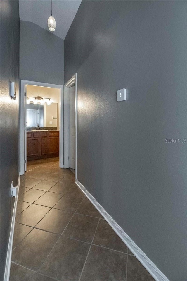 12654 Belcroft Dr, Riverview, FL 33579 - hall featuring dark tile patterned flooring, baseboards, and high vaulted ceiling