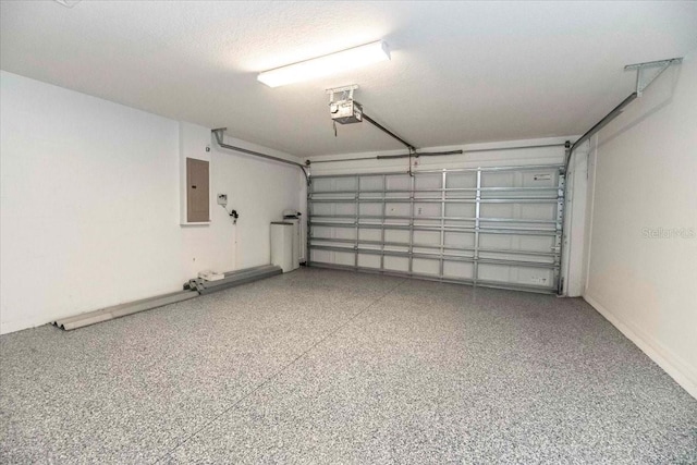 12654 Belcroft Dr, Riverview, FL 33579 - garage featuring electric panel, a garage door opener, and baseboards