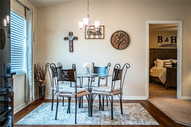 dining room with a chandelier, baseboards, and dark wood finished floors