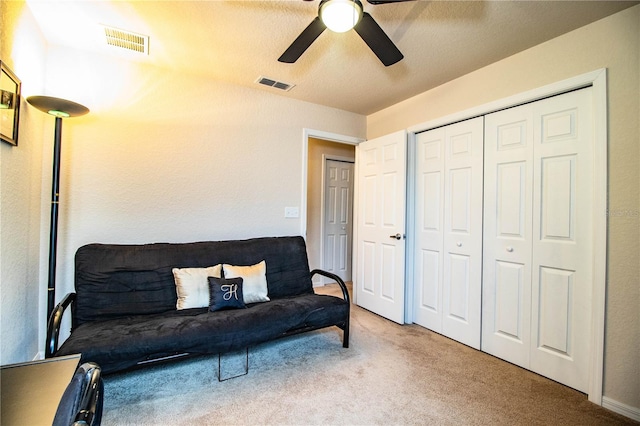 living area featuring ceiling fan and carpet floors