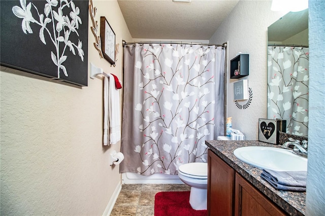 full bathroom featuring baseboards, vanity, a textured wall, toilet, and a textured ceiling