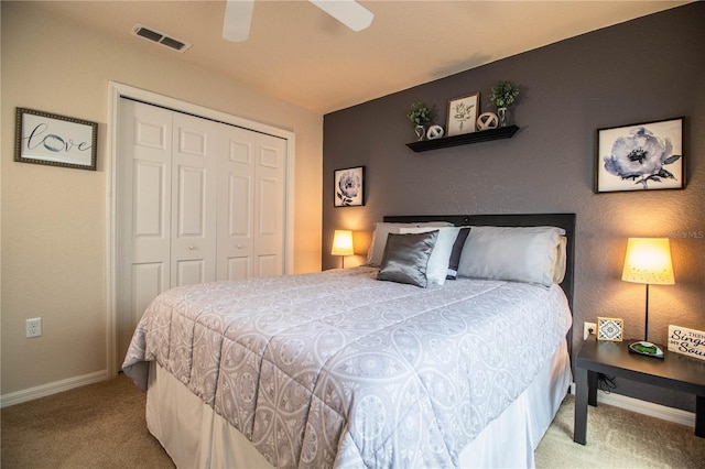carpeted bedroom featuring a closet, baseboards, and ceiling fan