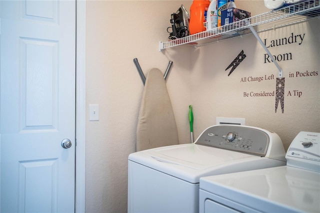 clothes washing area featuring separate washer and dryer