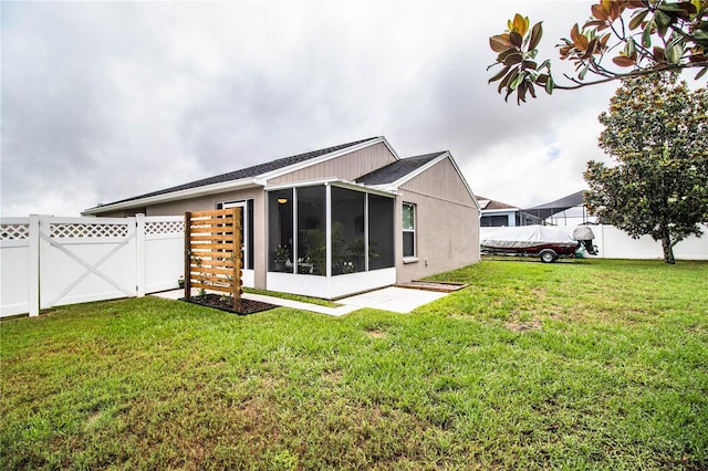 back of property featuring a sunroom