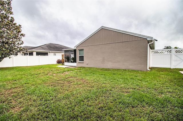 back of house featuring stucco siding and a sunroom