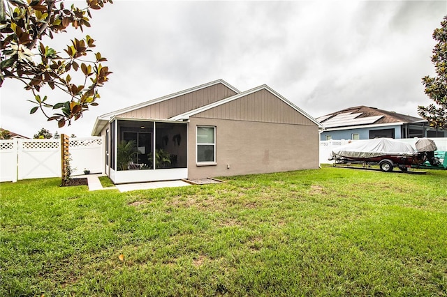 rear view of house featuring a sunroom