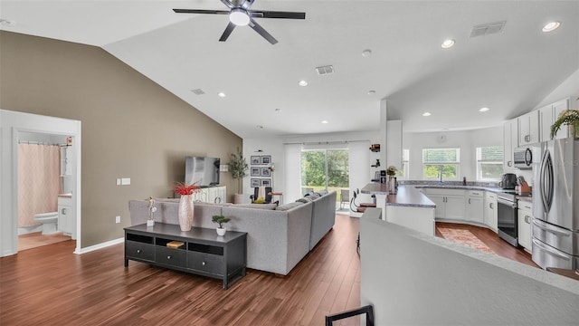 4582 Penkert Pl, Lakeland, FL 33811 - living area featuring vaulted ceiling, dark wood-style flooring, ceiling fan, and recessed lighting