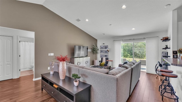 4582 Penkert Pl, Lakeland, FL 33811 - living area featuring lofted ceiling, wood finished floors, and recessed lighting