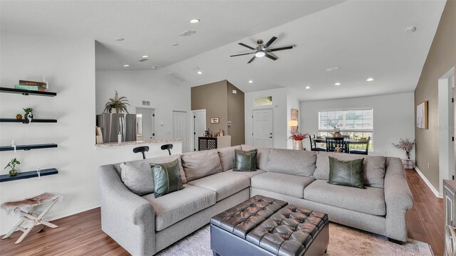 4582 Penkert Pl, Lakeland, FL 33811 - living area with wood finished floors, vaulted ceiling, recessed lighting, ceiling fan, and baseboards