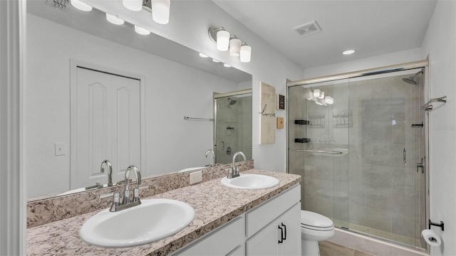 4582 Penkert Pl, Lakeland, FL 33811 - bathroom featuring double vanity, a stall shower, and toilet