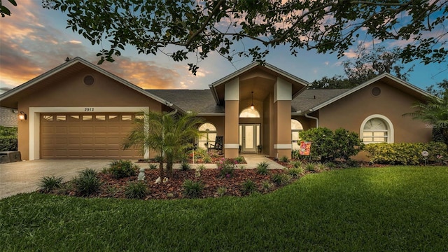 2912 Aston Ave, Plant City, FL 33566 - view of front of property with stucco siding, concrete driveway, a garage, a yard, and roof with shingles