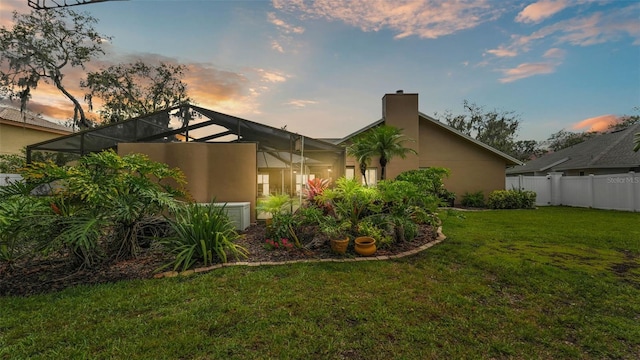 2912 Aston Ave, Plant City, FL 33566 - back of house with a chimney, stucco siding, and glass enclosure