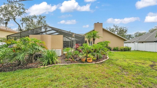 2912 Aston Ave, Plant City, FL 33566 - view of side of home featuring stucco siding, a chimney, and a lanai