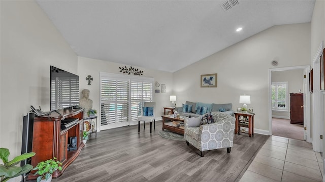 2912 Aston Ave, Plant City, FL 33566 - living area with wood finished floors, baseboards, and high vaulted ceiling