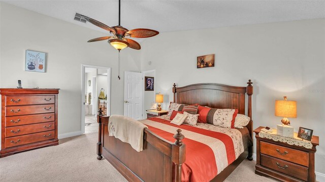 2912 Aston Ave, Plant City, FL 33566 - bedroom featuring light colored carpet, lofted ceiling, baseboards, connected bathroom, and a ceiling fan