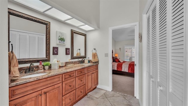 2912 Aston Ave, Plant City, FL 33566 - ensuite bathroom featuring a closet, double vanity, tile patterned flooring, and baseboards