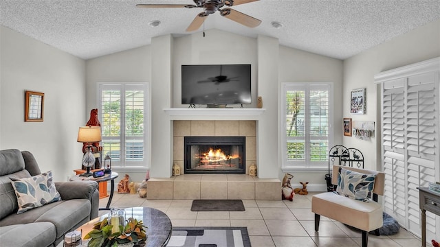 2912 Aston Ave, Plant City, FL 33566 - living room featuring lofted ceiling, a fireplace, a textured ceiling, tile patterned flooring, and healthy amount of natural light