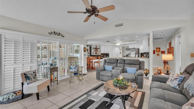 2912 Aston Ave, Plant City, FL 33566 - living room featuring a ceiling fan, lofted ceiling, and light tile patterned floors