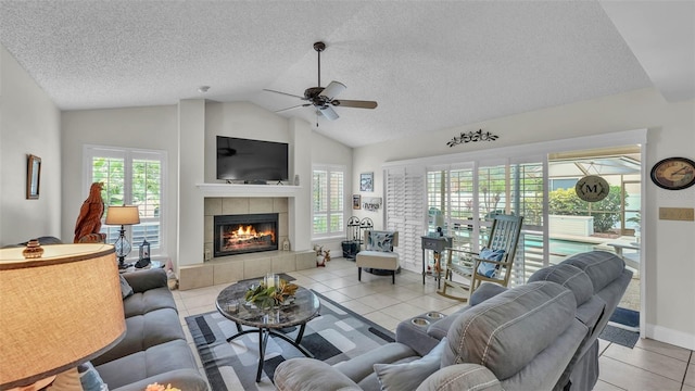 2912 Aston Ave, Plant City, FL 33566 - living area with lofted ceiling, a textured ceiling, a tiled fireplace, ceiling fan, and light tile patterned floors