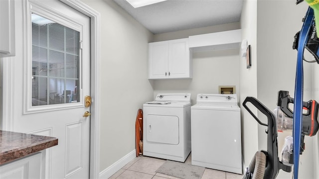 2912 Aston Ave, Plant City, FL 33566 - laundry room with washing machine and clothes dryer, cabinet space, light tile patterned flooring, and baseboards