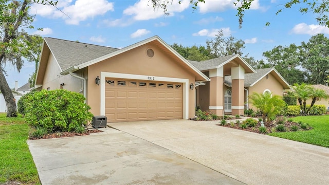 2912 Aston Ave, Plant City, FL 33566 - view of front of property featuring a garage, stucco siding, driveway, and a shingled roof