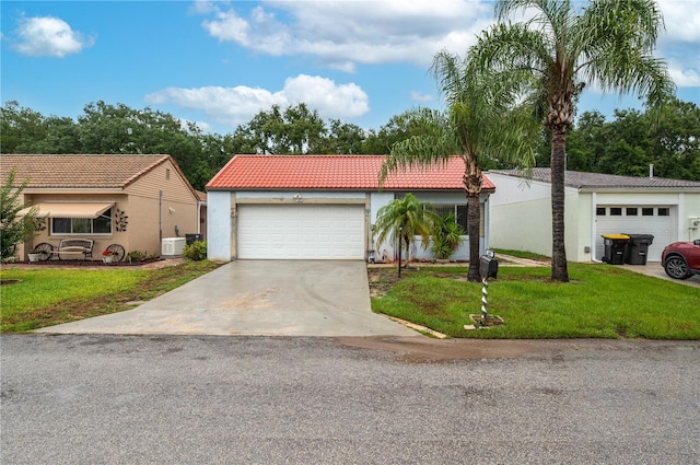 409 San Jose Dr, Winter Haven, FL 33884 - view of front of home featuring a tiled roof, stucco siding, a front lawn, and driveway