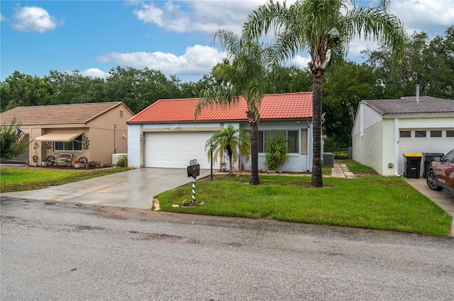 409 San Jose Dr, Winter Haven, FL 33884 - view of front facade featuring driveway, stucco siding, a garage, a front lawn, and a tiled roof