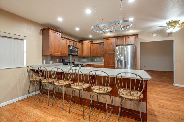 409 San Jose Dr, Winter Haven, FL 33884 - kitchen with stainless steel appliances, a peninsula, light wood-style floors, baseboards, and recessed lighting