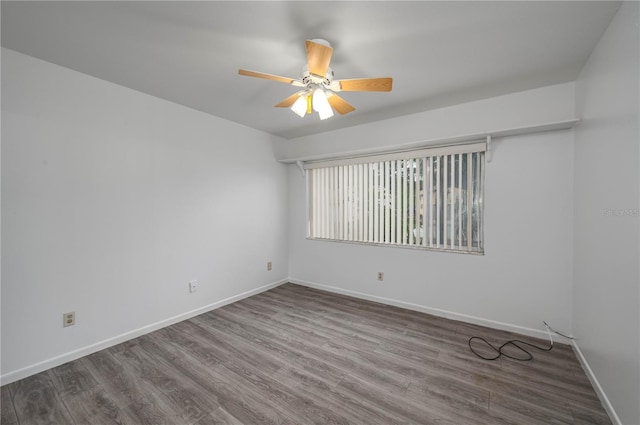 409 San Jose Dr, Winter Haven, FL 33884 - spare room with a ceiling fan, wood finished floors, and baseboards