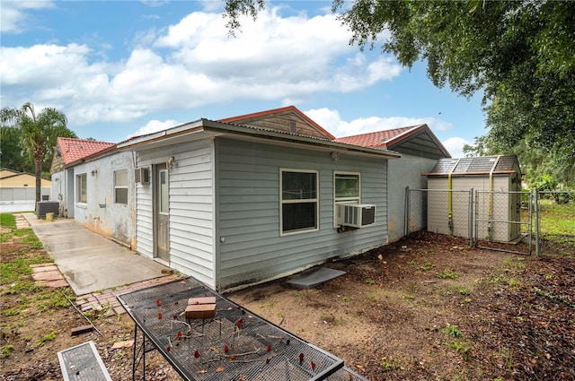 409 San Jose Dr, Winter Haven, FL 33884 - view of home's exterior featuring a gate, fence, central air condition unit, cooling unit, and metal roof