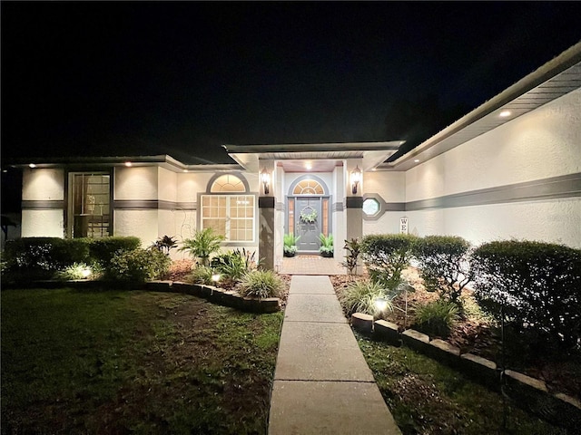 8760 Plantation Ridge Blvd, Lakeland, FL 33809 - exterior entry at twilight featuring stucco siding