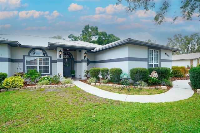 8760 Plantation Ridge Blvd, Lakeland, FL 33809 - view of front facade with stucco siding, a front lawn, and metal roof