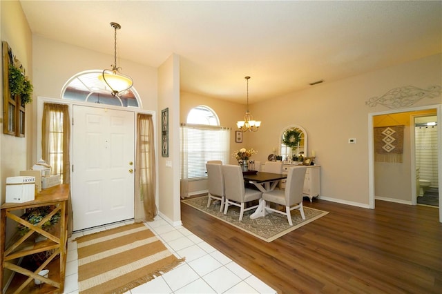 8760 Plantation Ridge Blvd, Lakeland, FL 33809 - foyer with a chandelier, wood finished floors, and baseboards