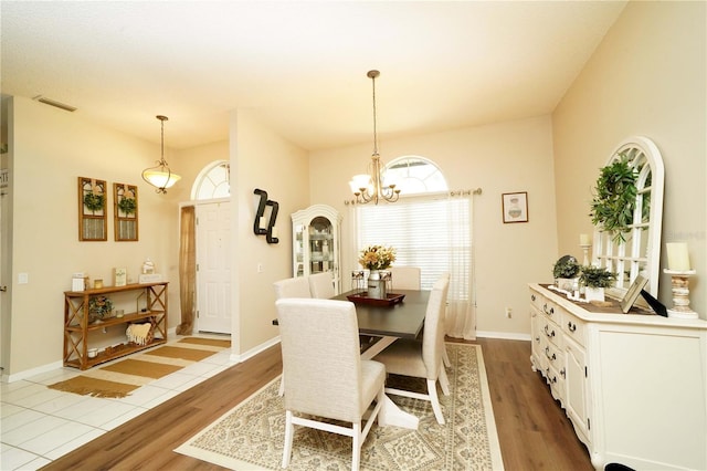 8760 Plantation Ridge Blvd, Lakeland, FL 33809 - dining area featuring wood finished floors, a chandelier, and baseboards