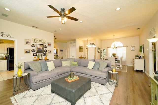 8760 Plantation Ridge Blvd, Lakeland, FL 33809 - living area featuring a ceiling fan, a chandelier, light wood-type flooring, a textured ceiling, and recessed lighting