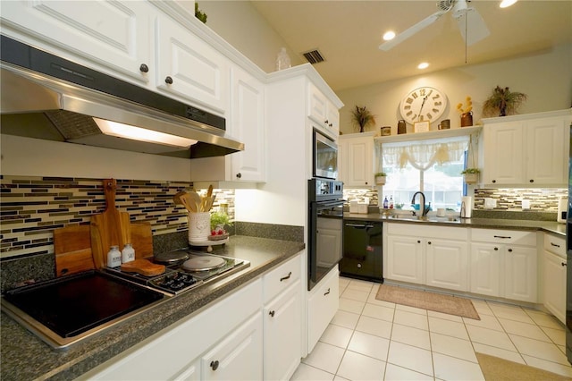 8760 Plantation Ridge Blvd, Lakeland, FL 33809 - kitchen featuring black appliances, under cabinet range hood, a sink, dark countertops, and tasteful backsplash